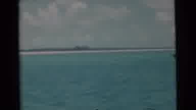 Miami Florida (1956): View Of Open Water With A Cloudy Sky And Land In The
