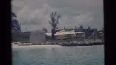 Miami Florida (1956): View Boat Plane Trees On Shore From Water With Clouds In Sky