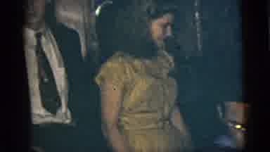 New York City (1956): Woman Wearing Yellow Dress Watches Man Wearing Blue Shirt