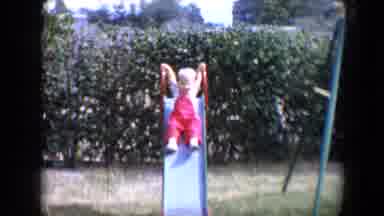 Tucson Arizona USA (1958): A Toddler In A Red Jumpsuit Holding On At The Top Of A