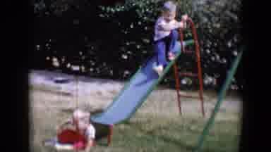 Tucson Arizona USA (1958): Two Children Playing Outside On A Sunny Day By Slide