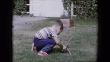 Tucson Arizona USA (1958): A Young Boy Plays With A Bow And Arrow Outside In The