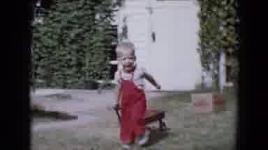 Tucson Arizona USA (1958): Child Running With Wagon By Grass On A Sunny Day