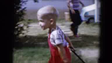Tucson Arizona USA (1958): Little Boy Wearing Red Overalls Pulling A Cardboard Box