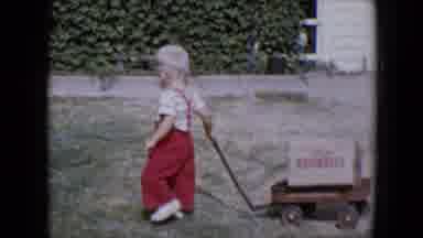 Tucson Arizona USA (1958): Boy In Red Overalls Pulling Wagon And Boy On Bicycle