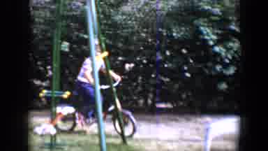 Tucson Arizona USA (1958): Child Riding A Bicycle Outside His Residence On A Sunny