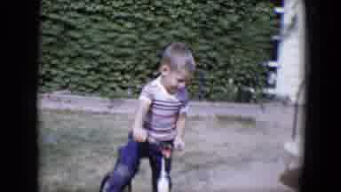 Tucson Arizona USA (1958): Young Boy Plays In The Backyard With His Bike And Wagon