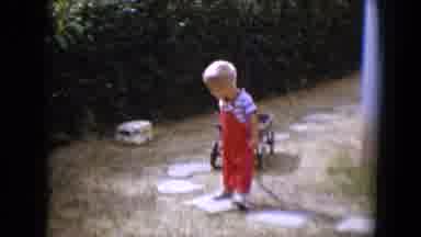 Tucson Arizona USA (1958): Little Boy Wearing Red Overalls Pulling A Small Empty