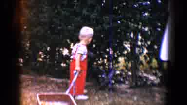 Tucson Arizona USA (1958): A Baby Playing With A Red Wagon And One Playing With A