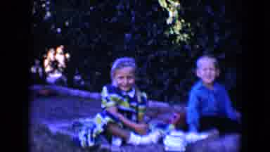 Tucson Arizona USA (1958): Boy And Girl Sit In Small Grey Sandbox On A Clear Day