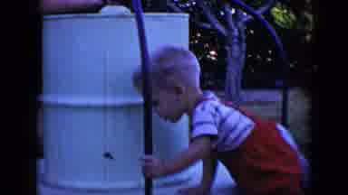Tucson Arizona USA (1958): Two Kids Spinning On White Merry-Go-Round On A Clear