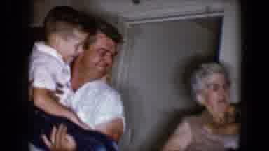 Tucson Arizona USA (1958): A Man Holding A Child About Six Years Old In A Home
