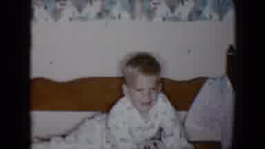 Tucson Arizona USA (1958): A Young Boy In His Pajamas Laying In Bed Laughing And