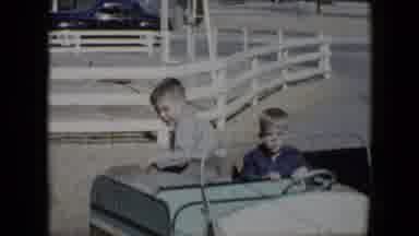 Tucson Arizona USA (1958): Two Young Boys Are Driven On A Blue Colored Cart