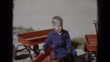 Tucson Arizona USA (1958): Little Boy Sitting In A Red Wagon With Two Other