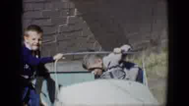 TUCSON ARIZONA USA-1958: Two Boys Playing With Pedal Car And On Swing Set