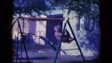 Tucson Arizona USA (1958): A Shirtless And Barefoot Boy Plays On A Swing While