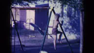 Tucson Arizona USA (1958): A Little Blond Boy Playing On A Swing Set By Himself In