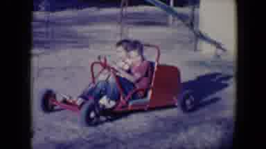 Tucson Arizona USA (1958): A Little Boy And Girl Drive A Red Toy Truck Around A