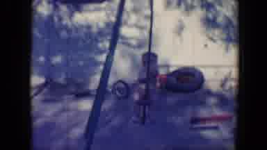 Tucson Arizona USA (1958): Boy Swings On Swing Set While A Second Boy Drives A Go