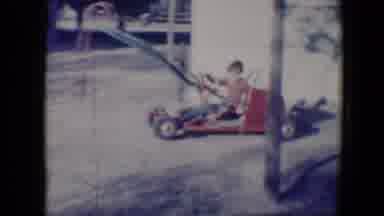 Tucson Arizona USA (1958): Young Boy Driving A Small Red Go Kart In Circles Waving