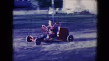 Tucson Arizona USA (1958): Boy Driving Around A Yard On Grass In A Red Go-Kart