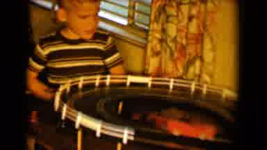 Tucson Arizona USA (1958): Two Young Kids Play With A Car Race Track Set On Top Of