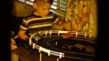 Tucson Arizona USA (1958): Two Boys Play With Mechanical Cars On Racetrack, And