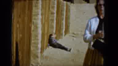 Tucson Arizona USA (1958): An Old Lady Walk Near A Fence With A Kid Sit On The