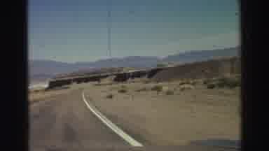 Lake Tahoe California (1969): A Vehicle Traveling Down The Highway Capturing A