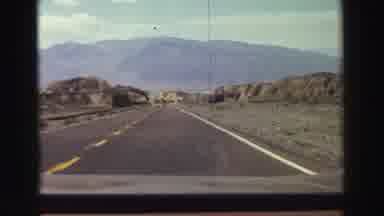 Lake Tahoe California (1969): Driving Down A Road With Mountains