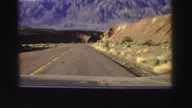 Lake Tahoe California (1969): A Vehicle Is Moving Mountains And Hills Are