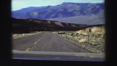 Lake Tahoe California (1969): A Car Is Driving On The Road Among The Mountains