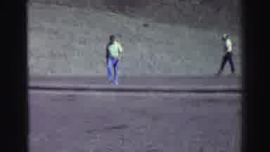 Lake Tahoe California (1969): Two Man Walking In Front Of A Big Grey Mountain