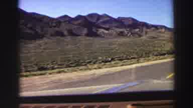 Lake Tahoe California (1969): Car Driving On A Road With View Of Mountains