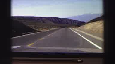 Lake Tahoe California (1969): Driving Slowly On Two Different Roads With Mountains