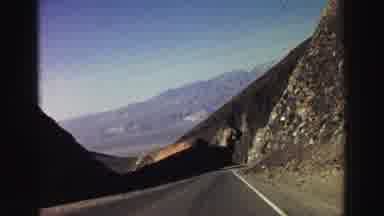 Lake Tahoe California (1969): Driving On A Road In Between Mountains With A