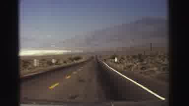 Lake Tahoe California (1969): Driving Down A Road And Passing Mountains Along The