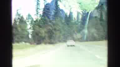 Lake Tahoe California (1969): Car On A Highway Surrounded By Trees And Mountains