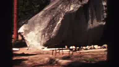 Lake Tahoe California (1969): A Picnic Table Sits Below A Massive Boulder Followed