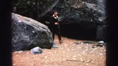 Lake Tahoe California (1969): A Man In Black Dress Is Walking On Rocky Mountain