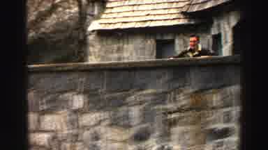 Lake Tahoe California (1969): Man Climbing On A High Stone Wall In The City Near