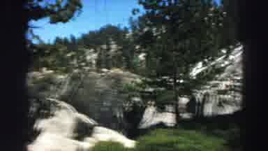 Lake Tahoe California (1969): Rocky Mountains Surrounded By Green Trees And Sunny
