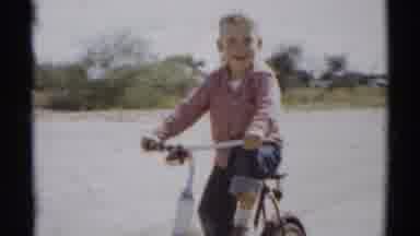 Disneyland California (1959): Happy Smiling Young Boy Riding His Bike Outside In A