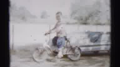 Disneyland California (1959): A Small Boy Rides A Bicycle With Small Wheels In The
