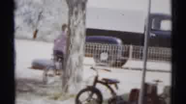 Disneyland California (1959): Little Boy Riding Bicycle Next To A Fence Cuts To