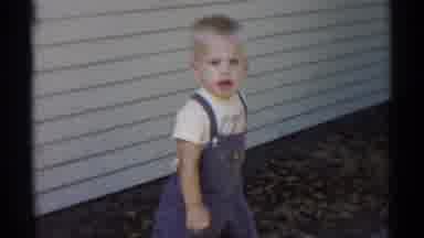 Disneyland California (1959): Boy Wearing Blue Overalls Walks Past Yellow