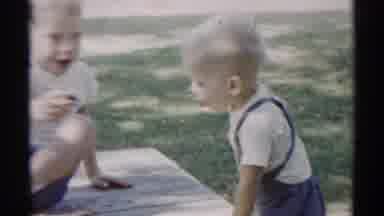 Disneyland California (1959): Two Boys Sitting In The Grass Sharing Some Kind Of