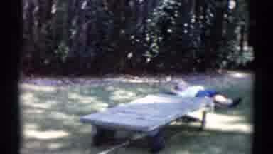 Disneyland California (1959): Child Lays On A Shaded Patch Of Grass While Younger