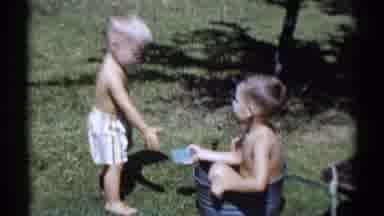Disneyland California (1959): Children Playing In Garden Boy Splashing Child With